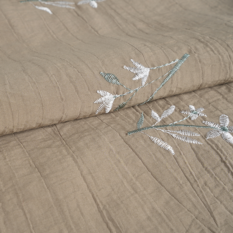 Tessuto antirughe con fiori ricamati di orchidee con semi di pesca